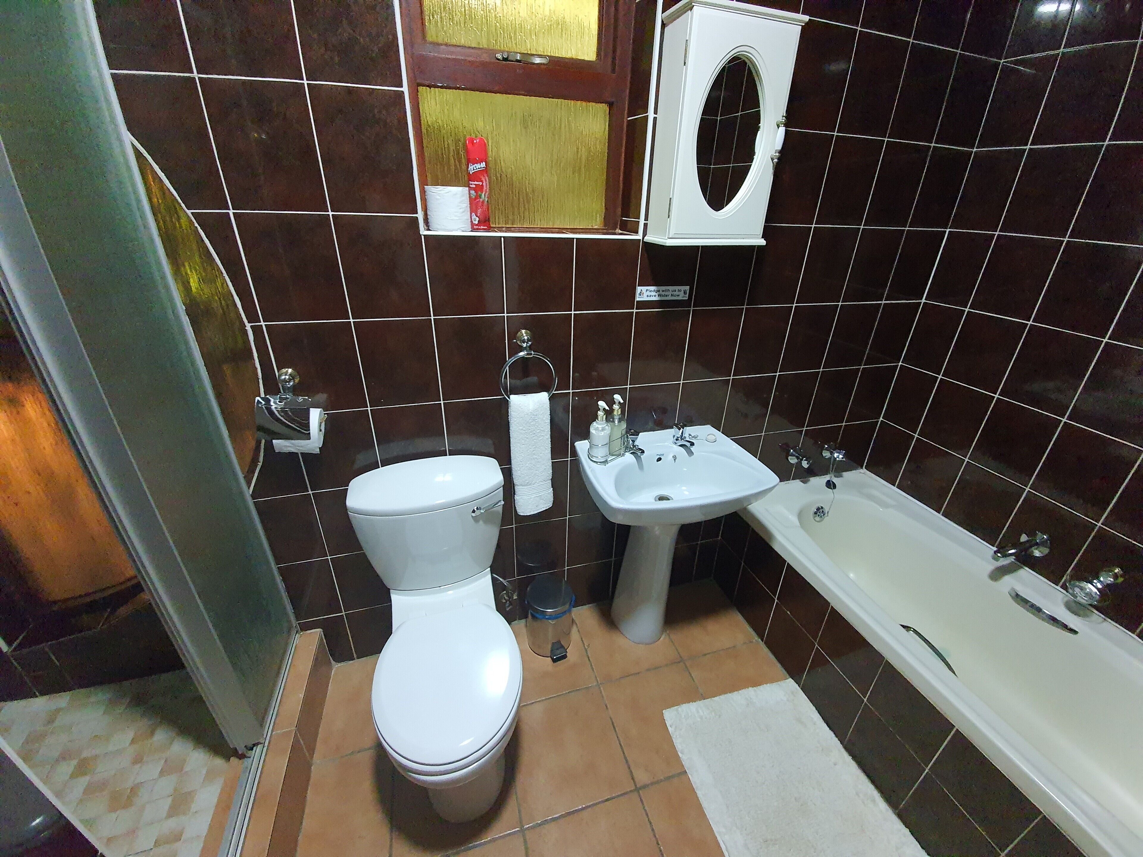 A bathroom with a toilet, sink, and bathtub.