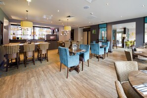 A hotel lobby with a bar area, seating arrangements, and a reception desk. - Premier Inn Sunderland City Centre (Sunderland)