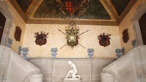 A grand staircase with ornate ceiling decorations and a central chandelier. - Parador Casa da Insua (Penalva Do Castelo)