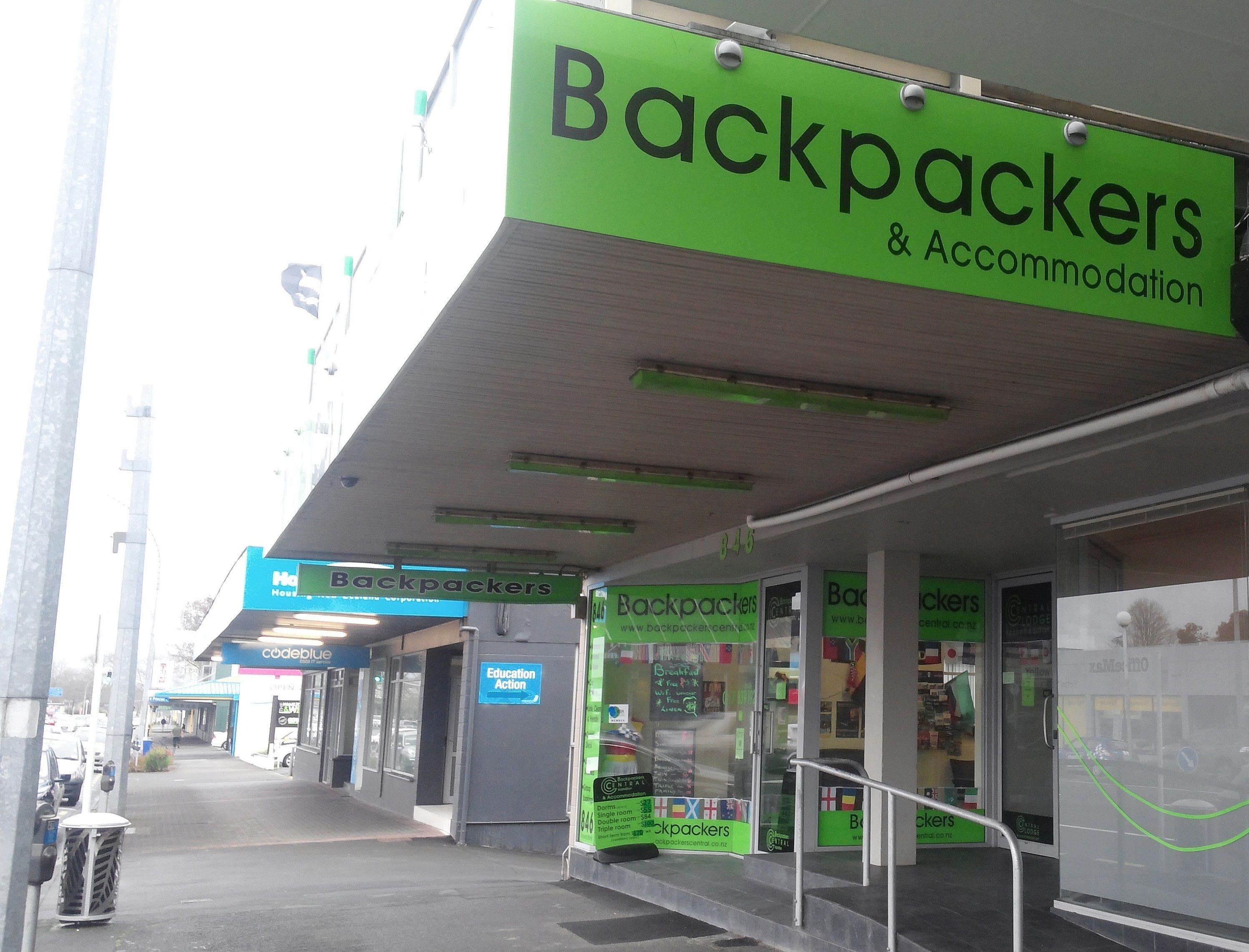 A storefront with a green sign reading "Backpackers & Accommodation".