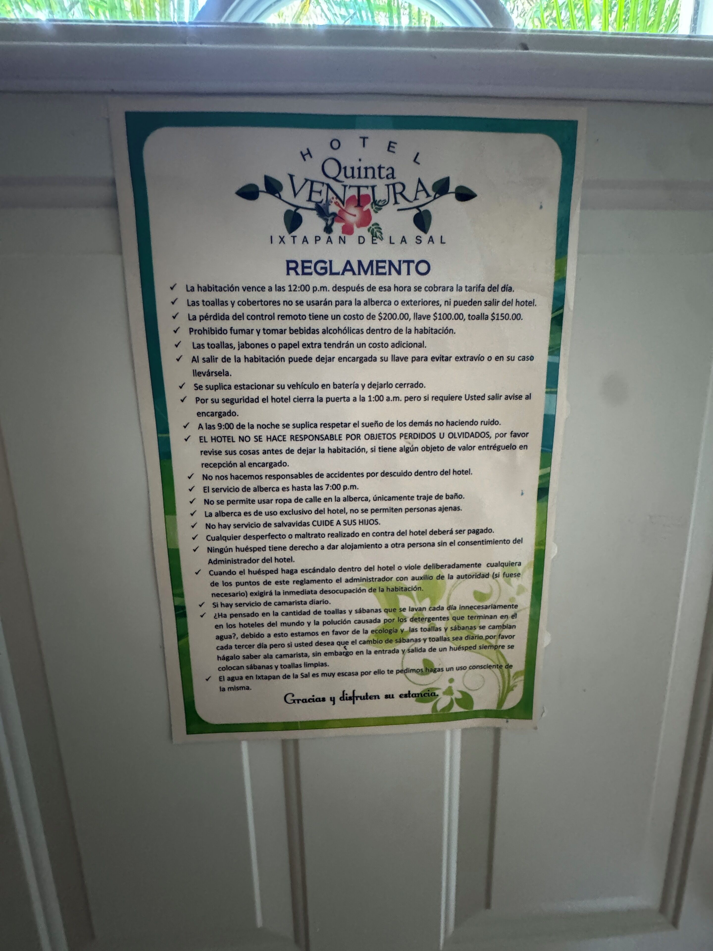 A hotel rule sign with guidelines for guests, including check-in time, use of towels, and other regulations.