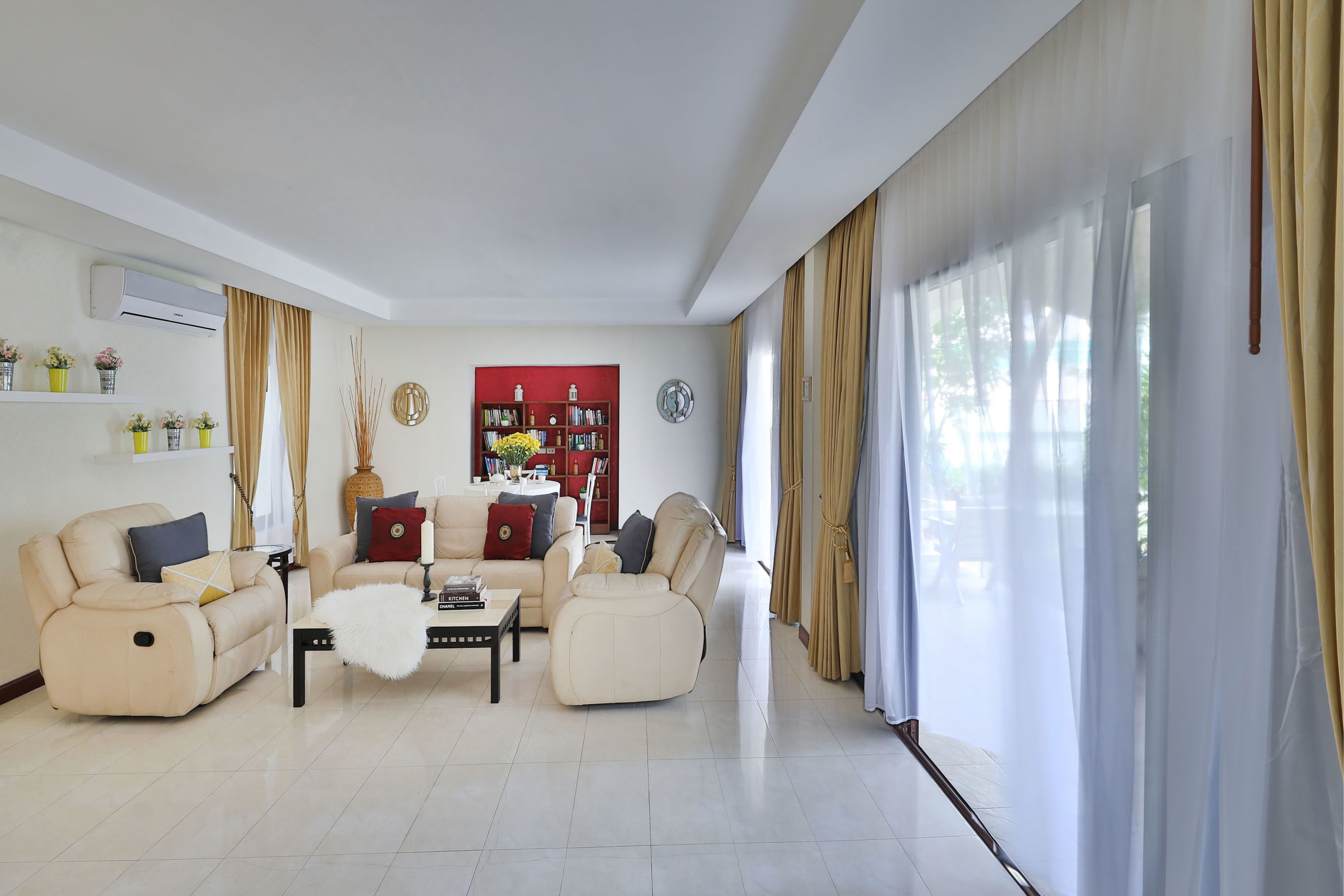 A modern living room with two sofas, a coffee table, and a bookshelf.