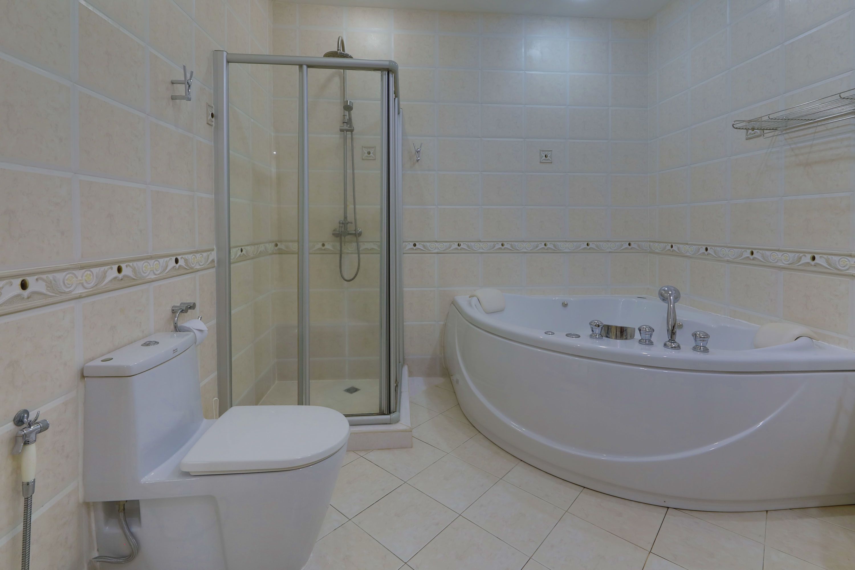 A bathroom with a toilet, shower enclosure, and a freestanding bathtub.