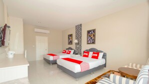 A hotel room with two beds, a sofa, a small table, and a coffee machine. - Pom Pom Residence (Hua Hin)