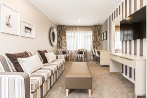 Premium One Bedroom | Living room | 50-inch flat-screen TV with cable channels, TV, Netflix