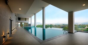 Relax by the pool with a view of the surrounding landscape.