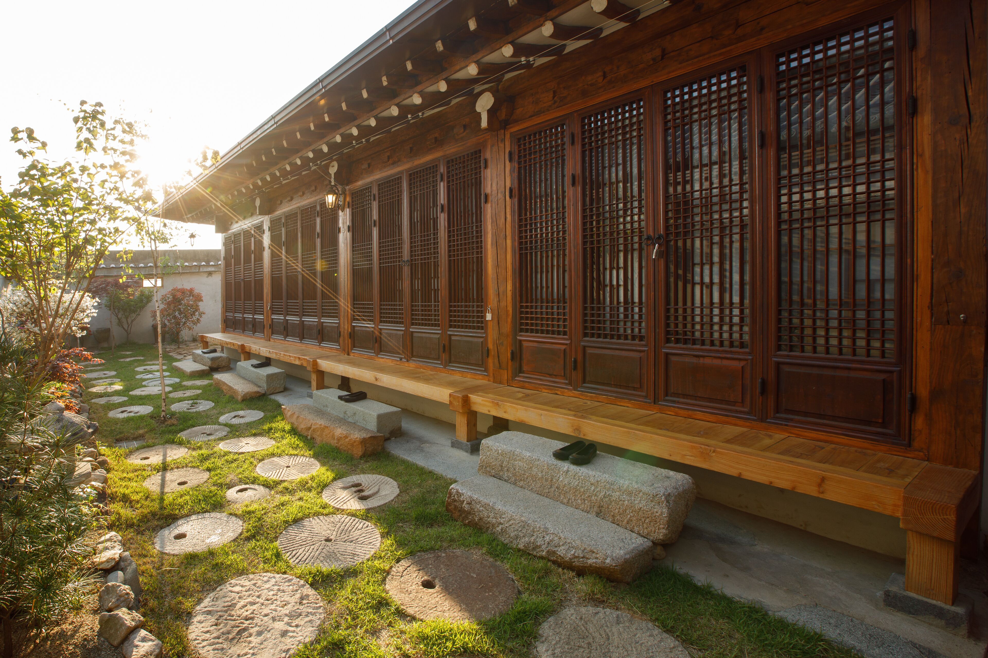 A traditional wooden building with a covered walkway and stone steps.