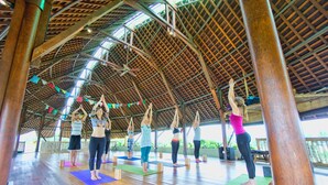 A spacious indoor area with a high wooden ceiling and natural light.