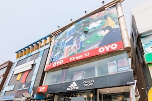 A multi-story building with an Adidas outlet store on the ground floor.