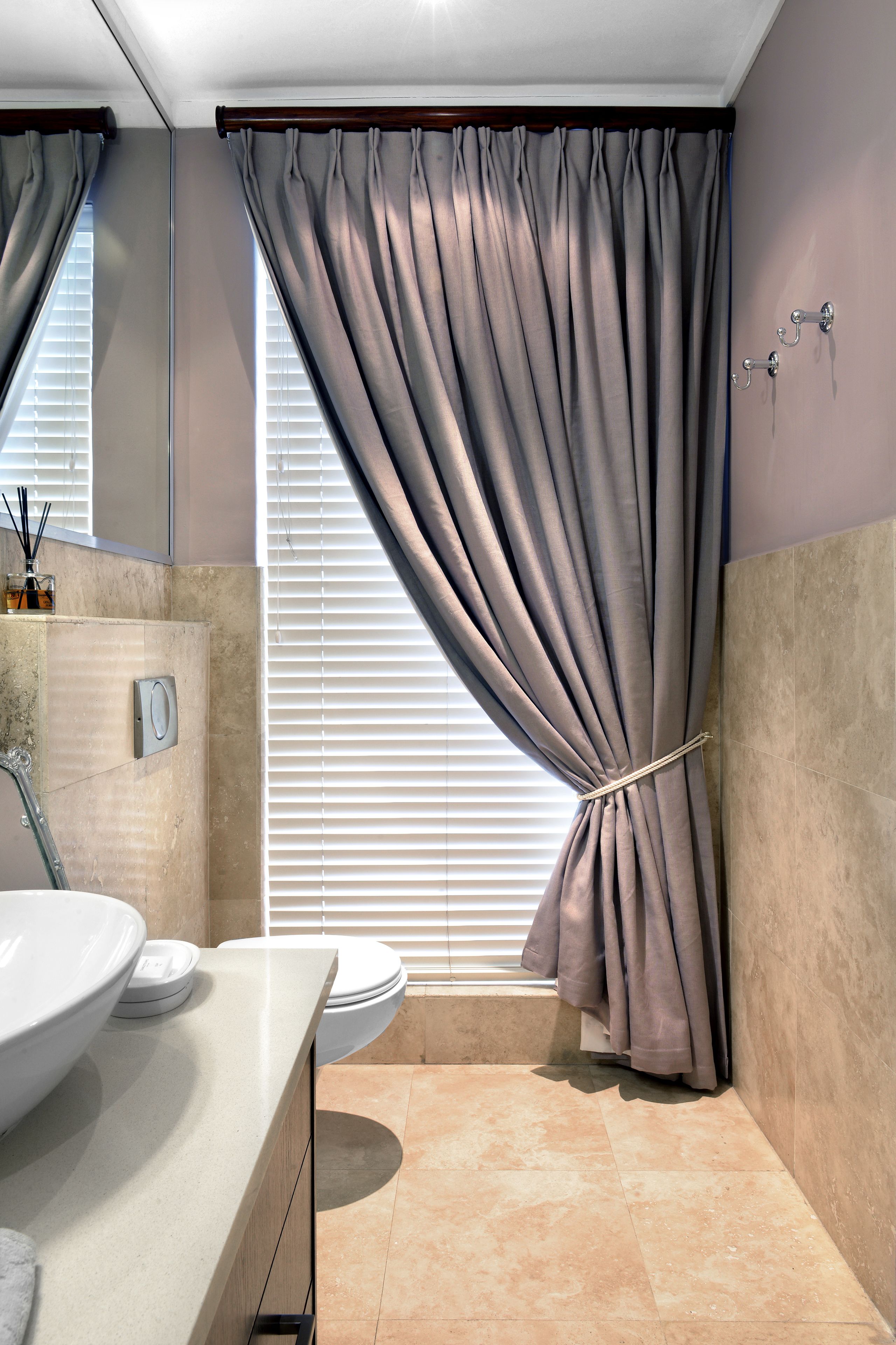 A modern bathroom with a large sink, toilet, and shower area.