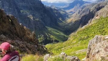 A mountainous landscape with a valley and rocky terrain.