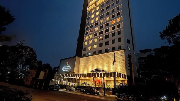 A tall hotel with multiple floors and a well-lit entrance. - GCC Northside Hotel (Mumbai)