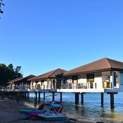 Overwater bungalows with balconies and stunning views of the surrounding landscape.