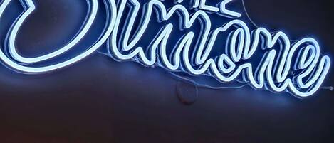 A neon sign with the text "Sanchez."