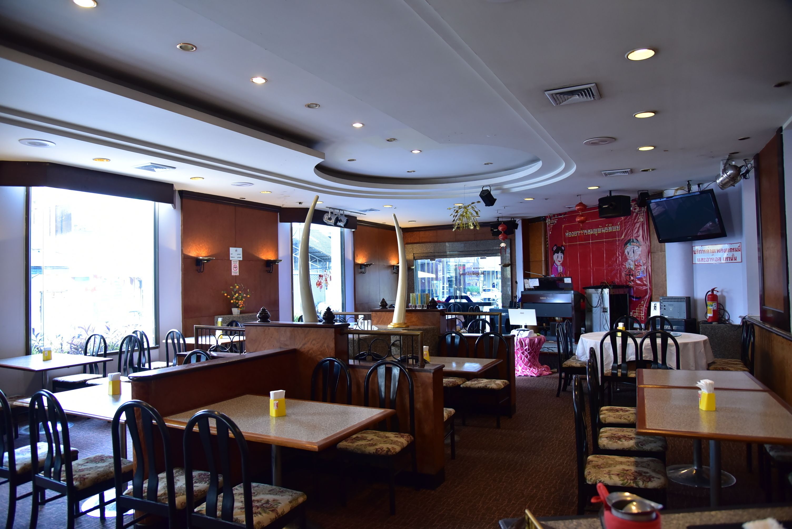 A restaurant with booths, tables, and a bar area.