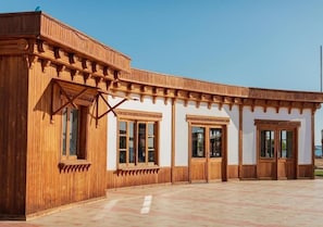 A wooden building with a covered entrance and large windows. - Bliss Laguna Beach Resort (Marsa Alam)