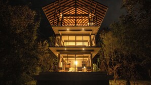 A multi-level wooden structure with a balcony, surrounded by trees. - Wild Grass Nature Resort (Dambulla)