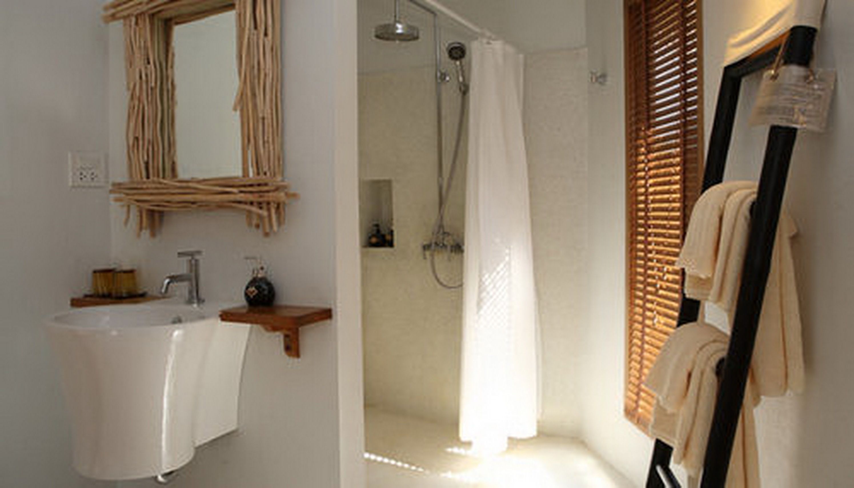 Un baño con lavabo, espejo, ducha y perchero para toallas.