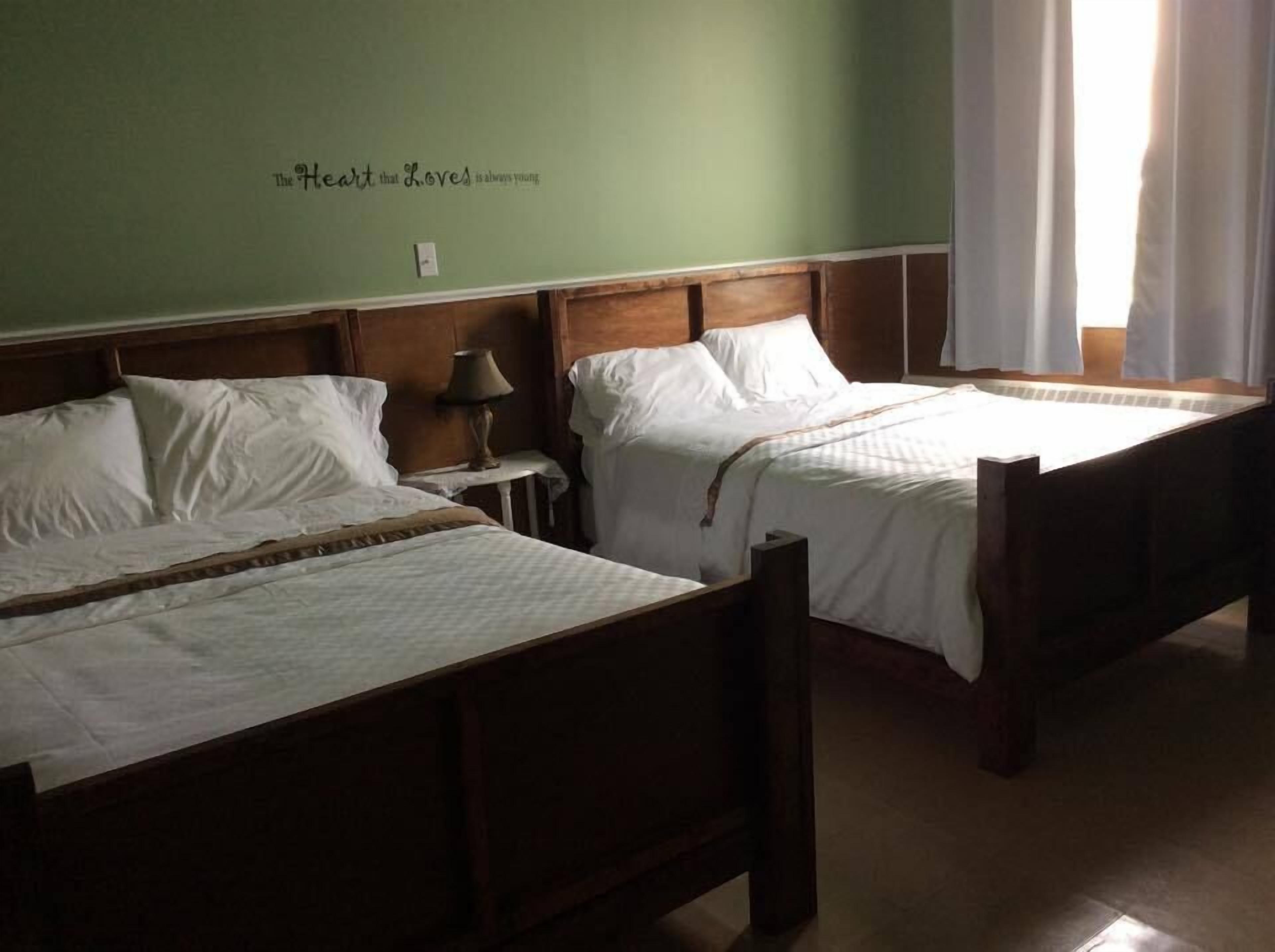room, 2 double beds | individually decorated, individually furnished, desk, iron/ironing board