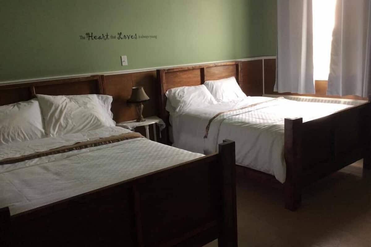 room, 2 double beds | individually decorated, individually furnished, desk, iron/ironing board