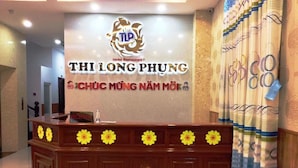 A reception desk with a sign for THI LONG PHUNG Hotel Restaurant. - Thi Long Phung Hotel (Phu Quoc)