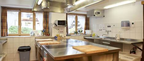 A modern kitchen with stainless steel appliances, a large island, and ample counter space.