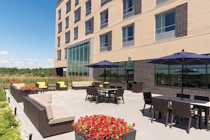 Relax in style with comfortable seating and lush greenery surrounding a central table.