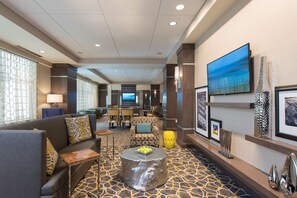 Relax in our spacious lobby with comfortable seating, a large flat-screen TV, and decorative touches.