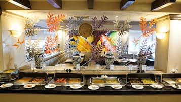 A buffet area with various food options and decorative vases.
