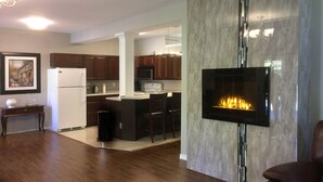 Suite, 1 Queen Bed, River View, Garden Area (The Studio Suite) | Living area | 50-inch flat-screen TV with satellite channels, TV, fireplace - The Tranquility Suites (Kingsclear)