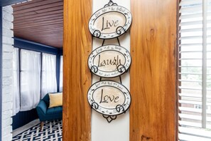 A wall with three signs: "Live," "Laugh," and "Love." - The Butler House B&B (Niagara Falls)