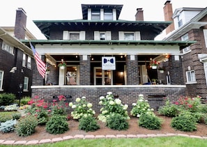 A two-story brick building with a green roof and a sign reading "The Butler House Bed & Breakfast". - The Butler House B&B (Niagara Falls)