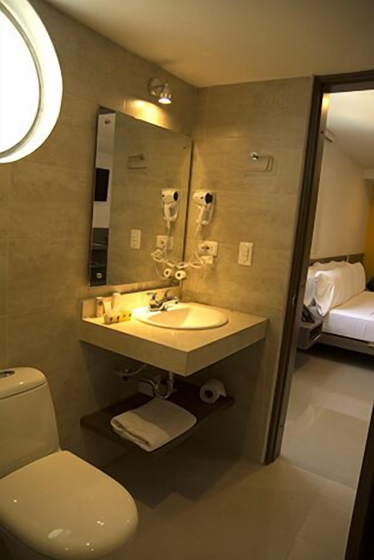 deluxe suite | bathroom | shower, rainfall showerhead, hair dryer, towels