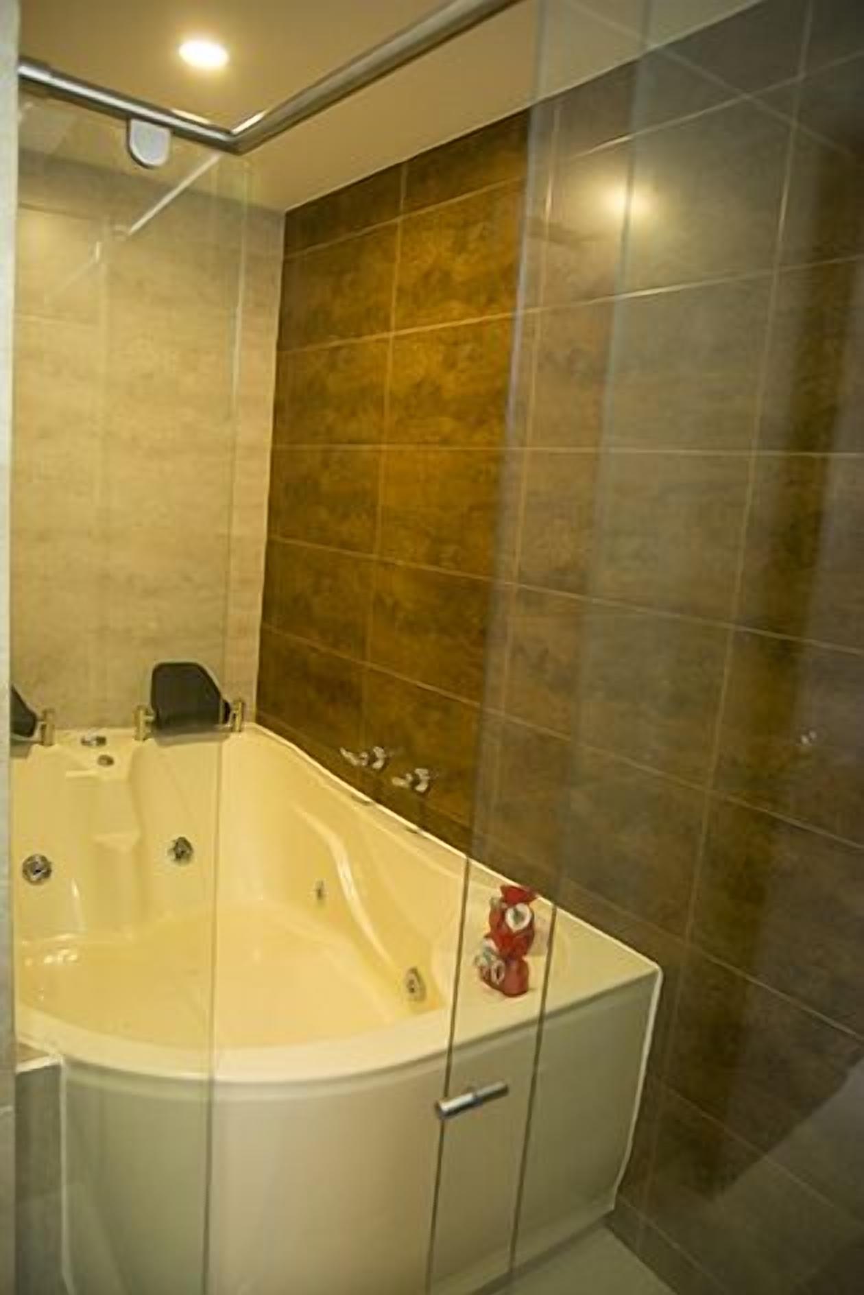 deluxe suite | bathroom | shower, rainfall showerhead, hair dryer, towels