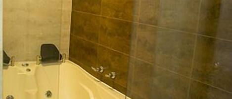 A bathroom with a freestanding bathtub, a shower enclosure, and a toilet.