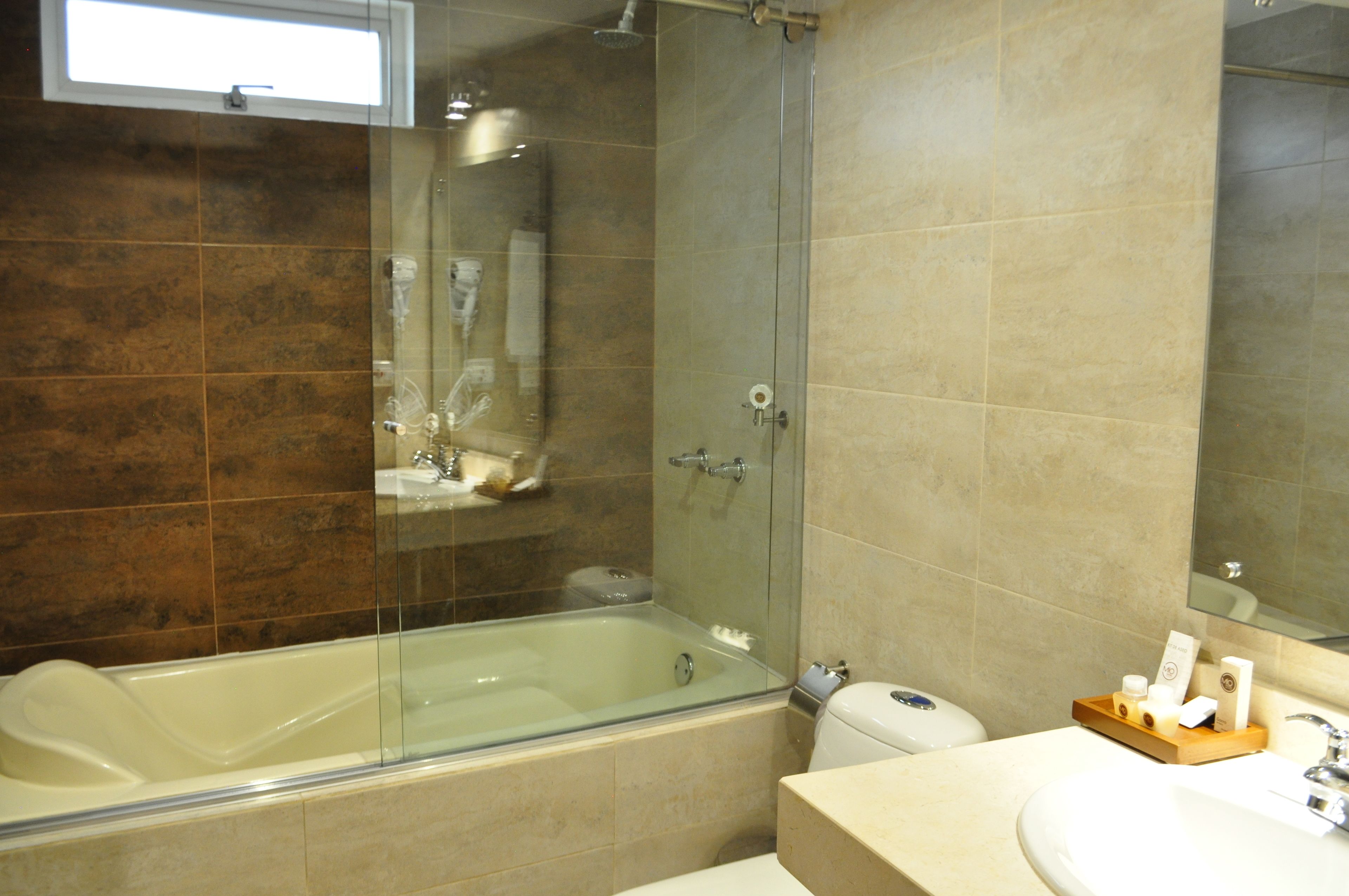 junior suite | bathroom | shower, rainfall showerhead, hair dryer, towels