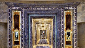 A grand hallway with marble flooring, ornate gold-framed mirrors, and a chandelier. - The Reverie Saigon Residential Suites (Ho Chi Minh City)