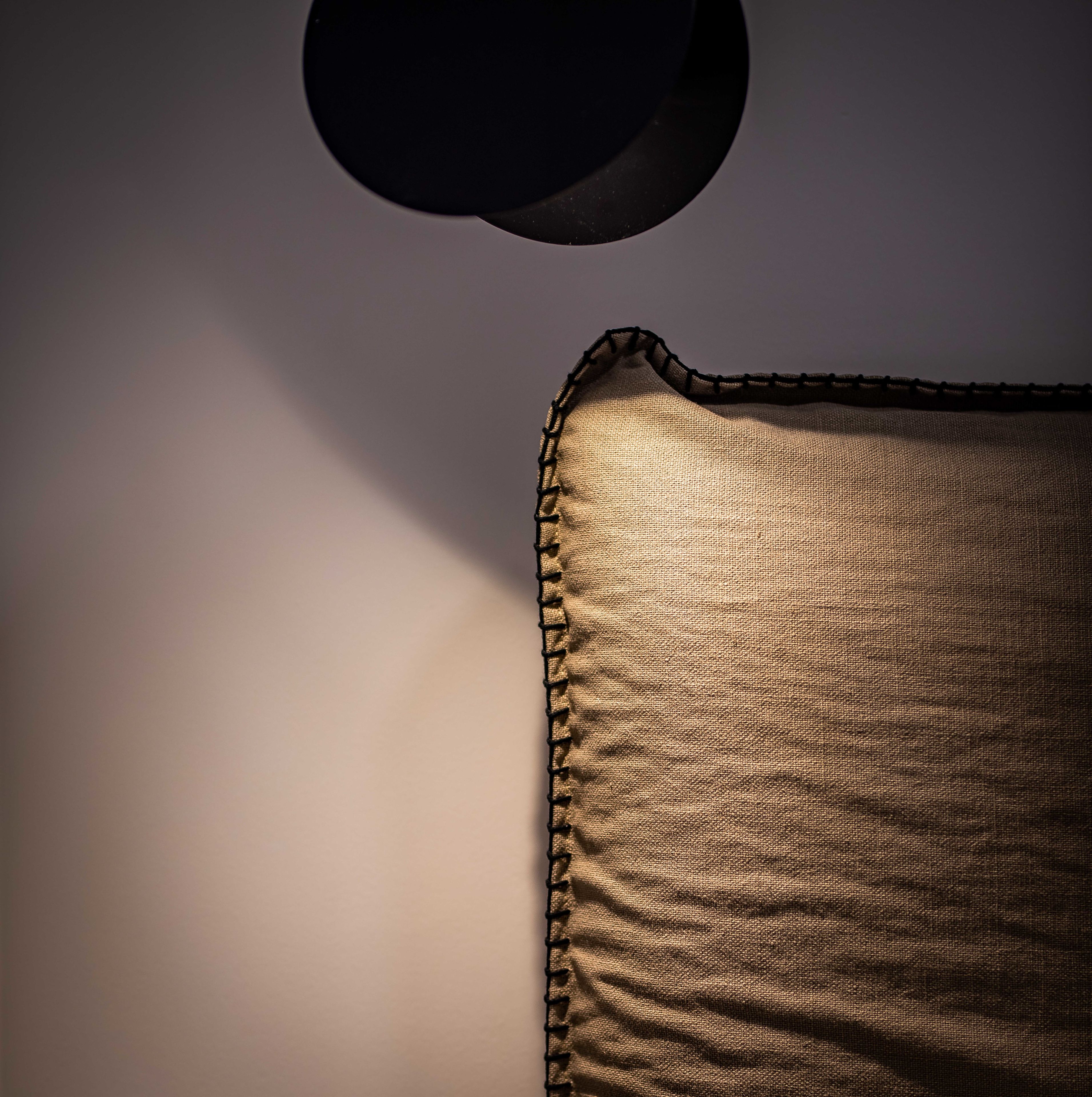 A close-up of a textured fabric with a dark border, possibly part of a piece of furniture or decor.