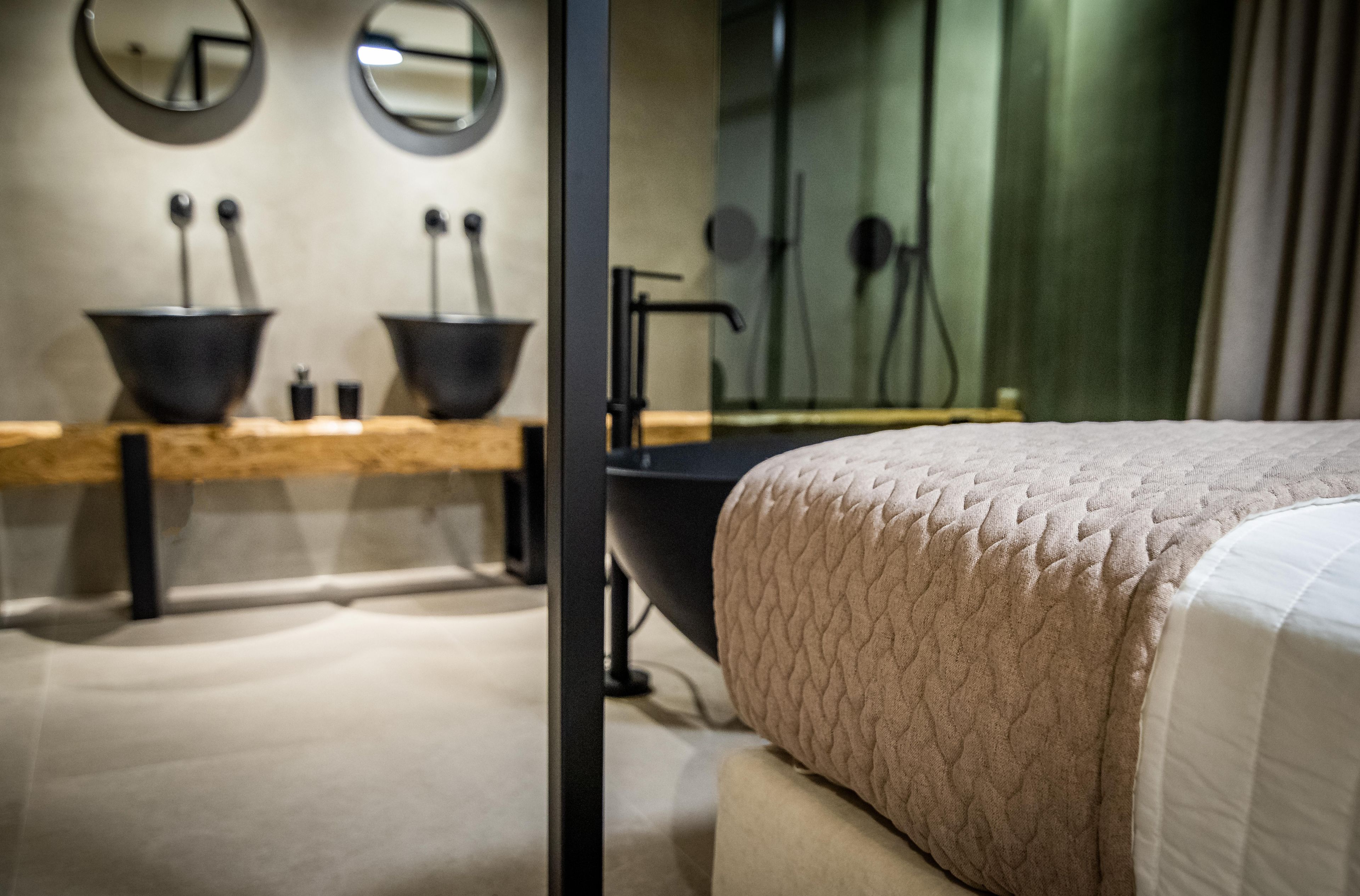A modern bathroom with a sink, mirror, and shower.
