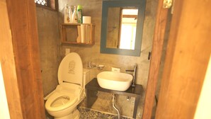 A bathroom with a toilet, sink, and mirror. - Ga In Dang (Jeonju)