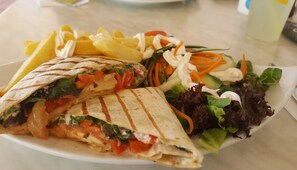 A plate with a sandwich, fries, and a salad. - Kama Lifestyle (Paralimni)