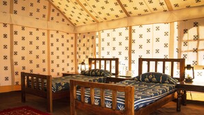 A room with two wooden beds, patterned curtains, and a red carpet. - Pushkar Adventure Desert Camp (Peesangan)