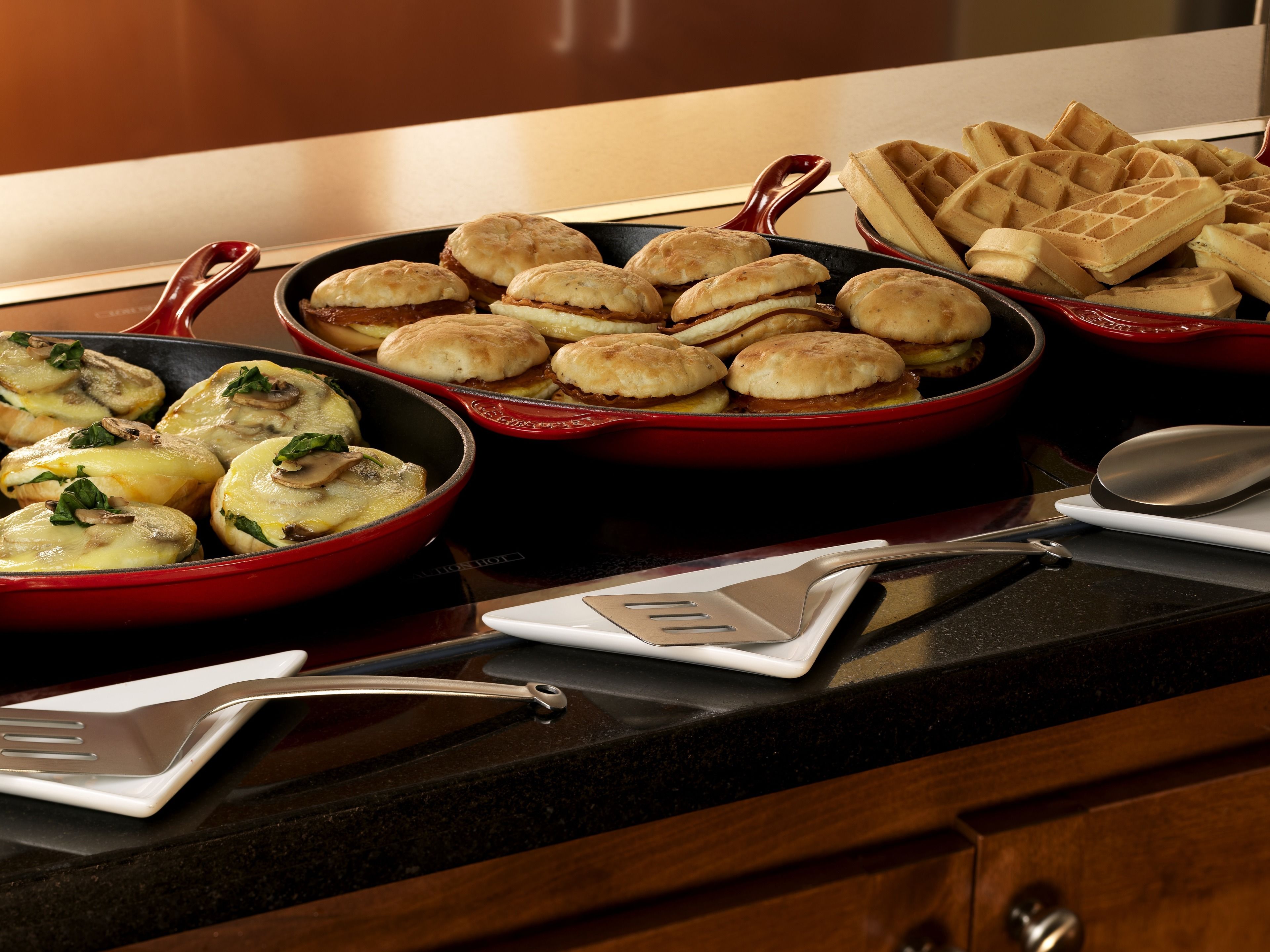A kitchen counter with various dishes including baked goods and casseroles.