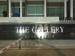 A building entrance with a sign that reads "THE GALLERY CONDO INNUM". - The Gallery Jomtien Beach Pattaya Condo By Dome (Pattaya)