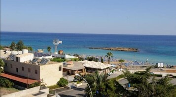 On the beach, white sand, sun loungers, beach umbrellas