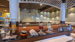 A buffet area with various food options, including cereal, fruits, and beverages. - TGI STAR Holidays Yercaud (Yercaud)