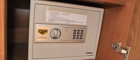A safe deposit box with a keypad and a lock.