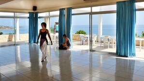 A spacious room with large windows, a tiled floor, and a view of the sea. - Aphrodite Beach Hotel (Neo Chorio)