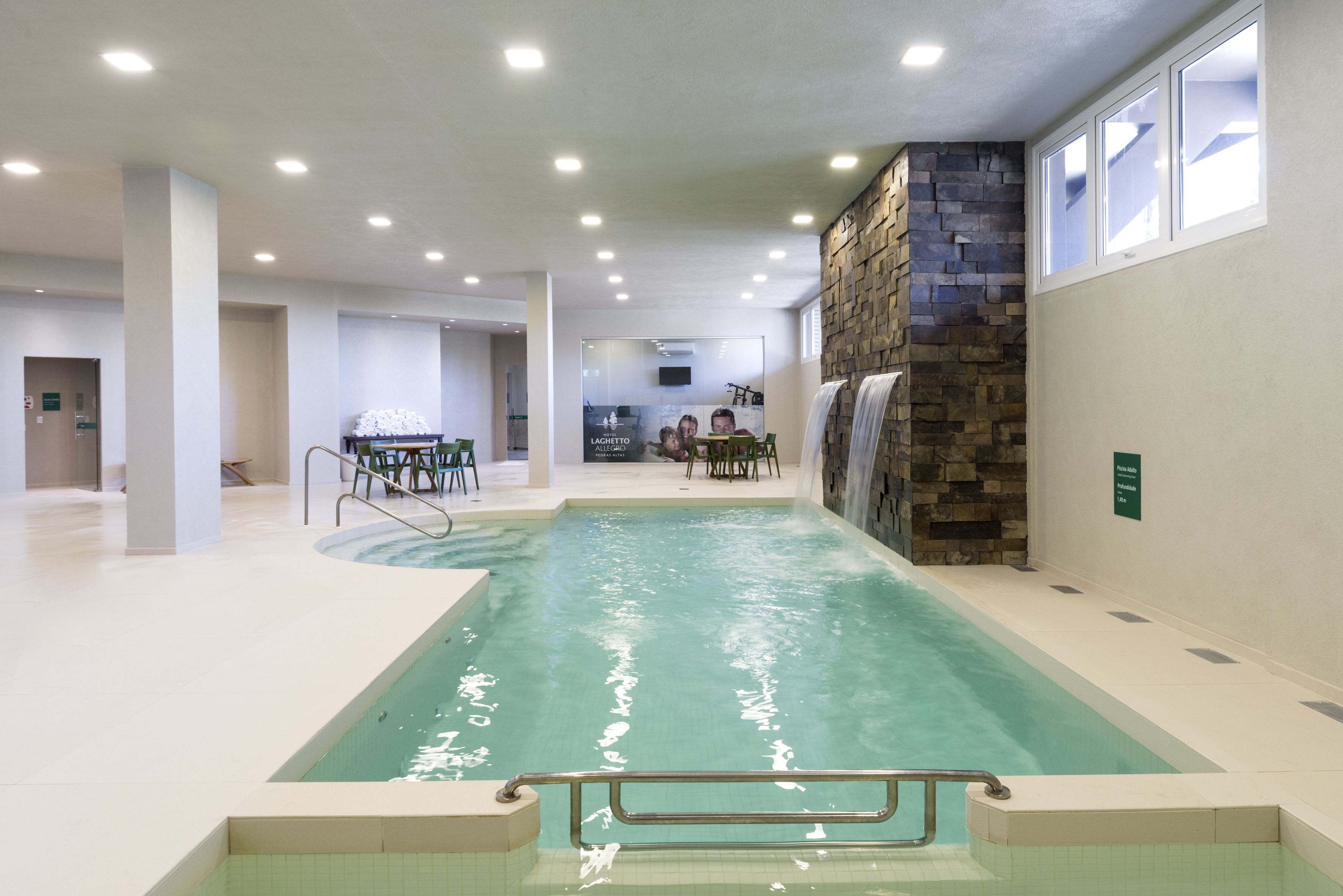 Una piscina techada, sillones reclinables de piscina