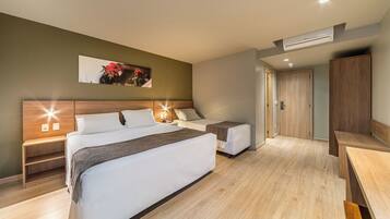 Deluxe Triple Room | Minibar, in-room safe, laptop workspace, blackout drapes